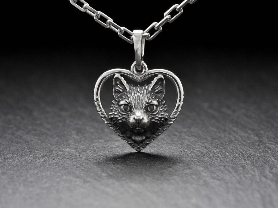 This beautiful and unique pendant features a lovely cat silhouette sitting in a heart-shaped frame. Handcrafted from high-quality sterling silver, this piece is perfect for cat lovers or anyone who appreciates intricate and detailed jewelry. __etsy:7357304418