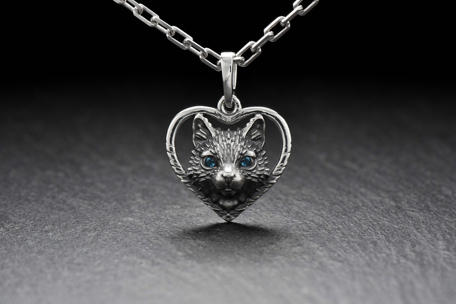 This beautiful and unique pendant features a lovely cat silhouette sitting in a heart-shaped frame. Handcrafted from high-quality sterling silver, this piece is perfect for cat lovers or anyone who appreciates intricate and detailed jewelry. __etsy:7357304418