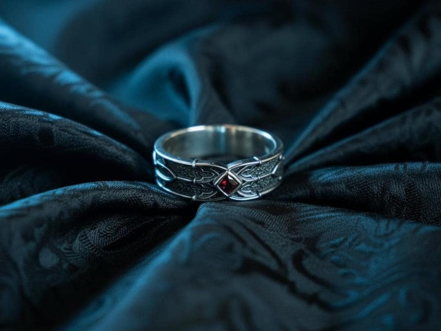 A men’s gothic fantasy ring with a textured darkened surface, silver sculpted lines, and a blood-red center stone. This ring offers a bold mix of elegance and strength, perfect for fans of dark artistry, role-play fashion, or medieval-inspired jewelry. Its sturdy build and eye-catching design make it a meaningful gift for special occasions. __etsy:7131752773