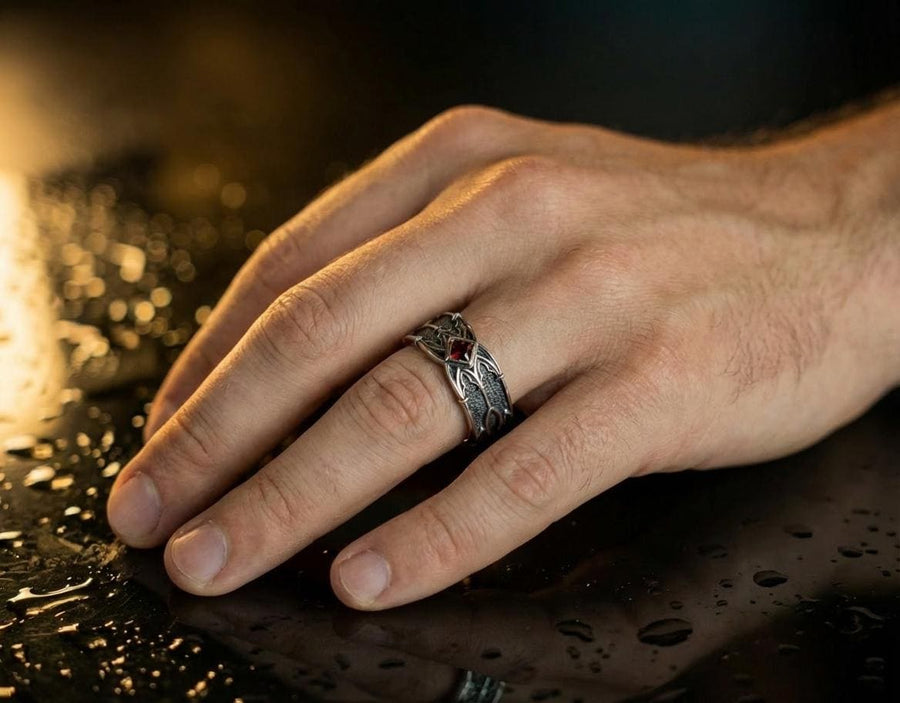 A men’s gothic fantasy ring with a textured darkened surface, silver sculpted lines, and a blood-red center stone. This ring offers a bold mix of elegance and strength, perfect for fans of dark artistry, role-play fashion, or medieval-inspired jewelry. Its sturdy build and eye-catching design make it a meaningful gift for special occasions. __etsy:7131752773