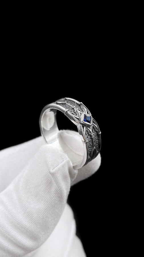 A men’s gothic fantasy ring with a textured darkened surface, silver sculpted lines, and a blood-red center stone. This ring offers a bold mix of elegance and strength, perfect for fans of dark artistry, role-play fashion, or medieval-inspired jewelry. Its sturdy build and eye-catching design make it a meaningful gift for special occasions. __etsy:7131752773