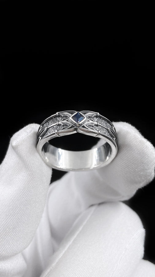 A men’s gothic fantasy ring with a textured darkened surface, silver sculpted lines, and a blood-red center stone. This ring offers a bold mix of elegance and strength, perfect for fans of dark artistry, role-play fashion, or medieval-inspired jewelry. Its sturdy build and eye-catching design make it a meaningful gift for special occasions. __etsy:7131752773