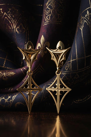 These earrings are crafted from high-quality silver and feature a one-of-a-kind gothic design that will elevate your style to the next level. The earrings are reimagined in 14k Rose Gold. The transformation softens the "edgy" gothic vibe into something more "Romantic" and "Victorian." The rose gold serves as a warm frame for the dark recesses, making the star motif look like a compass rose. This version feels like a __etsy:7217797486