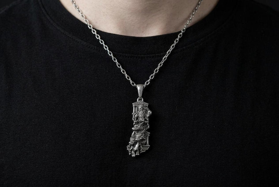 Crafted from premium solid sterling silver, this heavy, sculptural pendant demonstrates the striking visual impact of an oxidized patina. The dark sulfur treatment settles heavily into the microscopic crevices of the temple steps, the eagle's feathers, and Zeus's beard, providing a permanent shadow that makes the polished, raised metal elements shine brilliantly. A polished silver tapered bail connects the piece to a sturdy geometric chai __etsy:8113663105