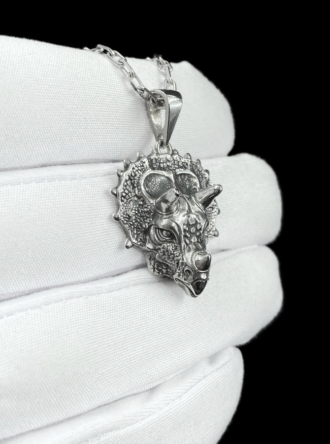 This silver triceratops head pendant necklace captures prehistoric strength in a lifelike, detailed design crafted from real silver. The textured skin, defined horns, and bold sculpting create a powerful, premium piece that feels both ancient and refined. __etsy:7922440525