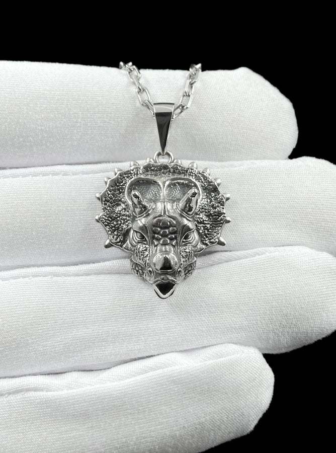 This silver triceratops head pendant necklace captures prehistoric strength in a lifelike, detailed design crafted from real silver. The textured skin, defined horns, and bold sculpting create a powerful, premium piece that feels both ancient and refined. __etsy:7922440525