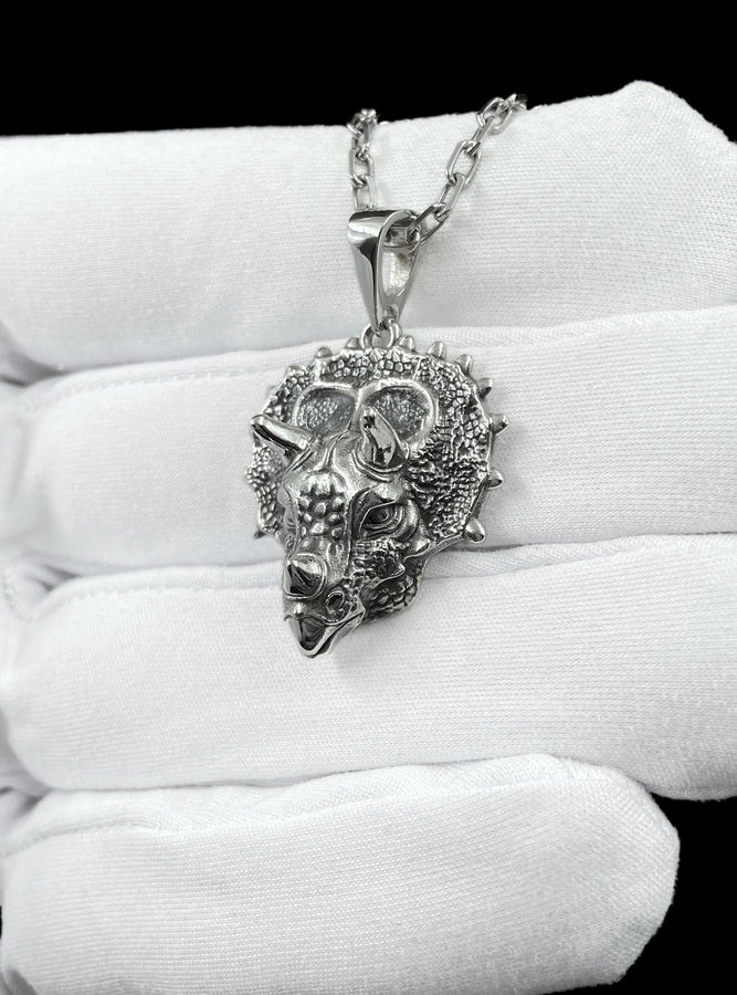 This silver triceratops head pendant necklace captures prehistoric strength in a lifelike, detailed design crafted from real silver. The textured skin, defined horns, and bold sculpting create a powerful, premium piece that feels both ancient and refined. __etsy:7922440525