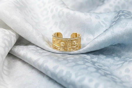 Reimagined in solid 14k yellow gold, this snow leopard landscape ring transforms from a rugged silver artifact into a radiant, opulent treasure. The warm golden metal softens the rocky mountain peaks, highlighting the intricate fur and pine tree details with a luxurious, sunlit glow. The deep recesses feature a soft matte finish rather than black oxidation, creating a striking contrast. This magnificent fine jewelry version elevates the wildlife __etsy:8027002925