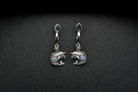 The dolphins represent intelligence and grace, while the wave design symbolizes the constant ebb and flow of life. These earrings are not only beautiful, but also a reminder to embrace life's ups and downs with strength and resilience.
