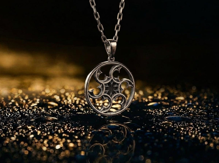 A detailed close-up of a circular sterling silver pendant resting on a dark blue, textured silk fabric. The pendant features an openwork design with swirling, crescent-like shapes radiating from a central four-pointed star. The intricate pattern resembles a gothic rose window or a celestial wheel. The raised metal surfaces are polished to a bright silver shine, contrasting beautifully against the dark, oxidized background recesses. (etsy image id: 7830974908)