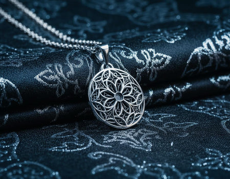 A detailed studio shot of a circular sterling silver pendant resting on a dark, textured slate background. The design is a geometric lattice based on the number four (quatrefoil). Four large teardrop-shaped arches meet in the center, subdivided by finer tracery lines. The raised silver network is polished, contrasting with the matte black oxidation in the negative spaces. __etsy:7446488454