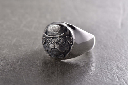 Made from high quality sterling silver, this ring features a unique design that depicts a pug dog in a gentleman's style. His expressive features and hat add humor and personality to the look.