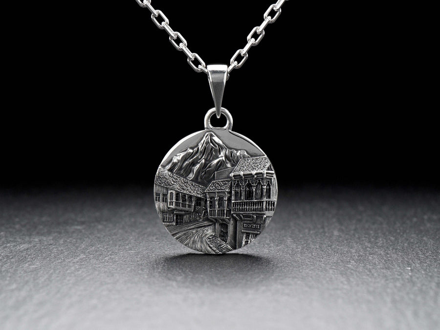 This beautiful pendant is the perfect souvenir to remember your trip to the beautiful city of Tbilisi. It features a detailed, hand-crafted design of the skyline of Tbilisi, Georgia.