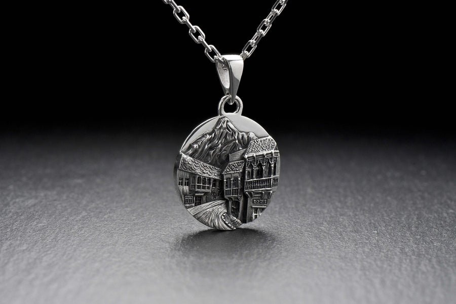 This beautiful pendant is the perfect souvenir to remember your trip to the beautiful city of Tbilisi. It features a detailed, hand-crafted design of the skyline of Tbilisi, Georgia.