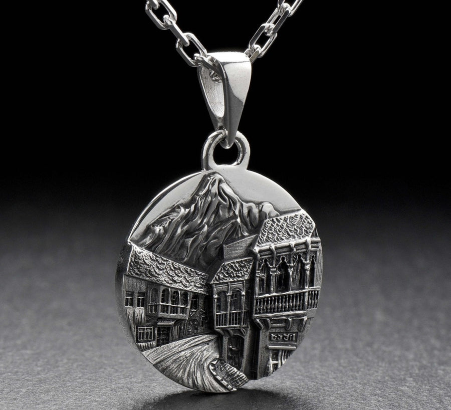 This beautiful pendant is the perfect souvenir to remember your trip to the beautiful city of Tbilisi. It features a detailed, hand-crafted design of the skyline of Tbilisi, Georgia.