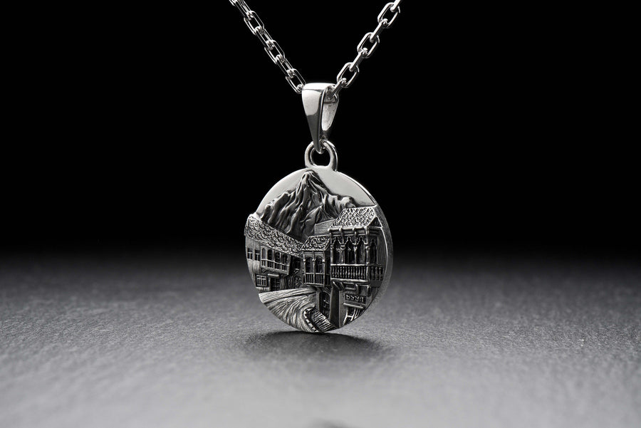 This beautiful pendant is the perfect souvenir to remember your trip to the beautiful city of Tbilisi. It features a detailed, hand-crafted design of the skyline of Tbilisi, Georgia.