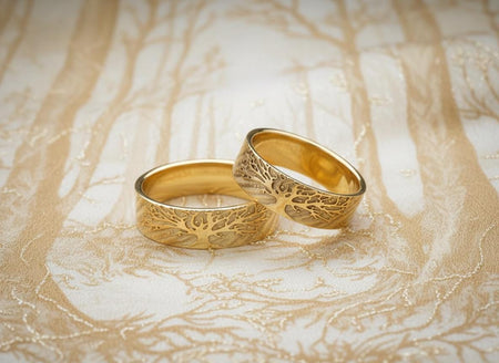 The Tree of Life set is reimagined in 14k Yellow Gold. The transformation gives the trees a "Golden Hour" glow, as if bathed in sunset light. The background texture is matte-finished rather than black, creating a subtle tone-on-tone relief. This version feels warm, radiant, and abundant, perfect for a summer solstice wedding. __etsy:7444575320