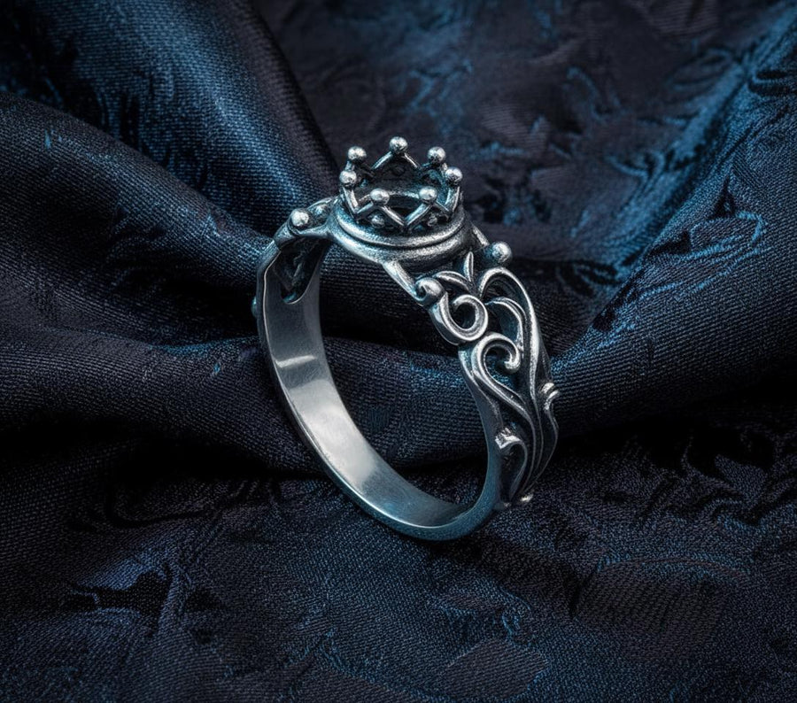 A macro studio shot of a sterling silver solitaire ring. The focal point is a round, clear gemstone (simulated diamond or white sapphire) held in a secure bezel setting. The band is composed of openwork filigree scrolls that swirl around the stone, creating a lace-like effect. The silver features a high-contrast finish: bright, polished vines against a matte black, oxidized background that adds depth and definition. (etsy image id: 7490069229)