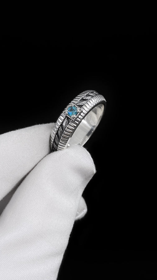 This sterling silver wedding band features intricate Victorian-inspired detailing, including finely engraved laurel leaves that wrap around the entire ring. The ribbed architectural edges create depth and texture, giving the piece an antique character reminiscent of handcrafted heirloom jewelry. Ideal for men or women who appreciate historic design and meaningful symbolism in their wedding band. __etsy:7473345891