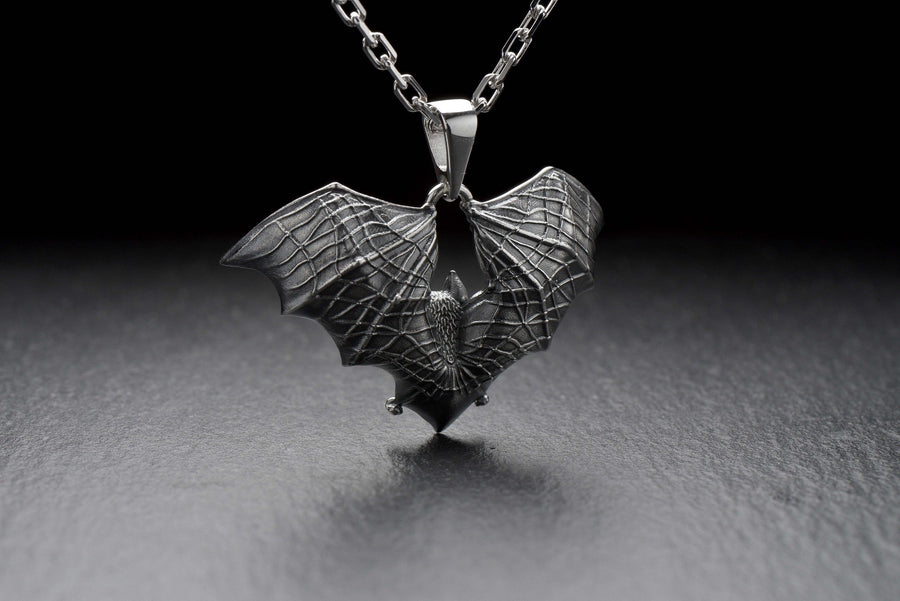 Featuring a detailed bat with outstretched wings, our unique design is sure to stand out. Don't let the darkness keep you down—power up your style with a silver bat pendant today! (etsy image id: 6086867201)