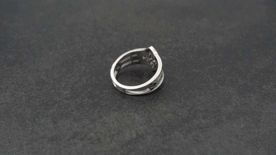 Detailed view of the ring's texture, showing the stippled, hammered finish inside the recessed arches. This "granulation" effect adds a raw, artisan quality to the piece, distinguishing it from mass-produced jewelry. The 925 sterling silver has been treated with sulfur to achieve a permanent dark patina in the low points, ensuring the architectural pattern remains visible even with daily wear. The metal looks solid and durable, suit (etsy image id: 6980758746)