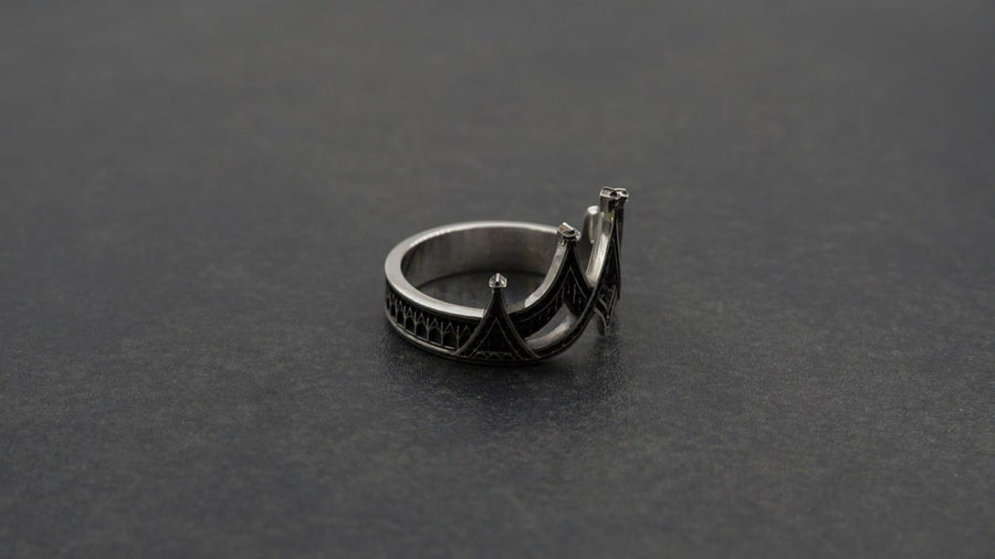 statement ring,	silver ring,	rare ring, gothic architecture,	goth ornament,	gothic window, The image highlights the depth of the casting. The 925 sterling silver features two distinct textures: the smooth, reflective structural lines and the gritty, matte "chainmail" texture within the arches. The oxidation gives the ring an antique patina, making it look like a forged artifact rather than a stamped piece of metal. (etsy image id: 7028750895)