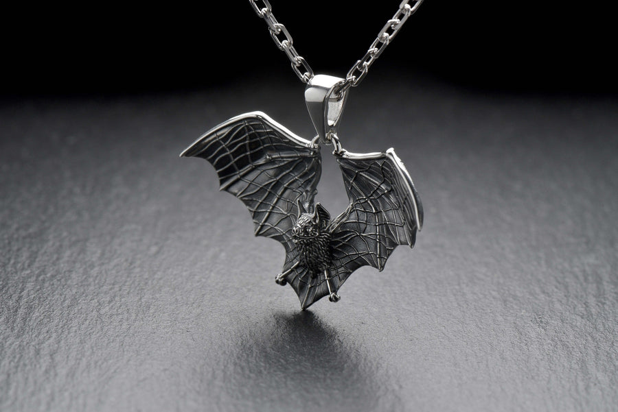 Featuring a detailed bat with outstretched wings, our unique design is sure to stand out. Don't let the darkness keep you down—power up your style with a silver bat pendant today! (etsy image id: 6086867201)
