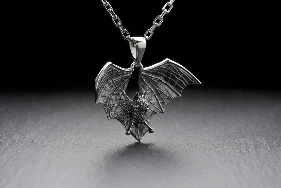 Featuring a detailed bat with outstretched wings, our unique design is sure to stand out. Don't let the darkness keep you down—power up your style with a silver bat pendant today! (etsy image id: 6086867201)