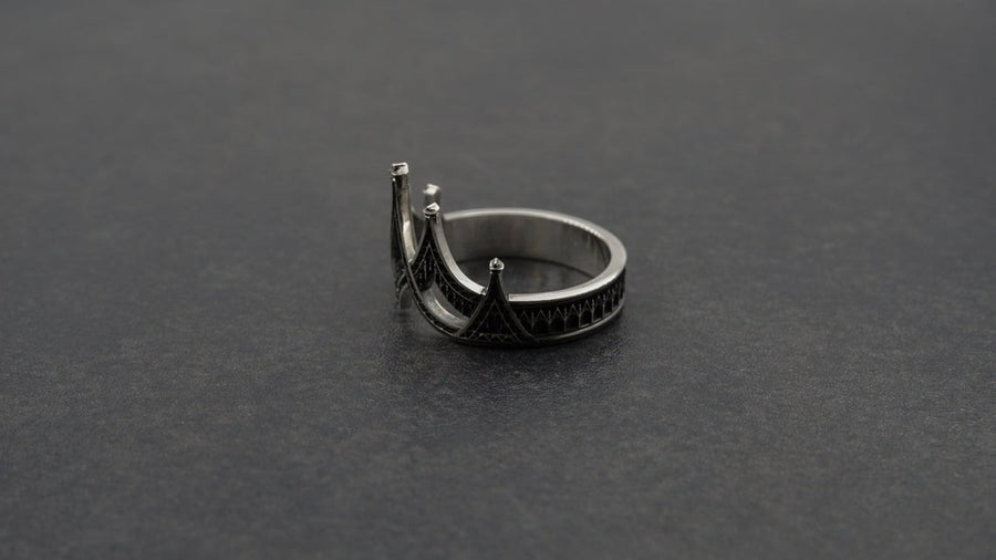 statement ring,	silver ring,	rare ring, gothic architecture,	goth ornament,	gothic window, The image highlights the depth of the casting. The 925 sterling silver features two distinct textures: the smooth, reflective structural lines and the gritty, matte "chainmail" texture within the arches. The oxidation gives the ring an antique patina, making it look like a forged artifact rather than a stamped piece of metal. (etsy image id: 7028750895)