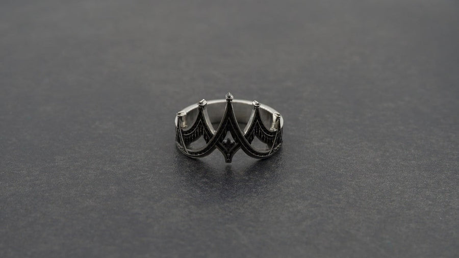 statement ring,	silver ring,	rare ring, gothic architecture,	goth ornament,	gothic window, The image highlights the depth of the casting. The 925 sterling silver features two distinct textures: the smooth, reflective structural lines and the gritty, matte "chainmail" texture within the arches. The oxidation gives the ring an antique patina, making it look like a forged artifact rather than a stamped piece of metal. (etsy image id: 7028750895)