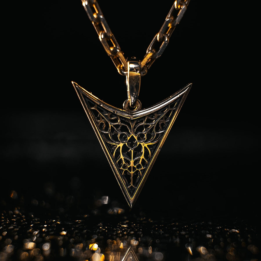 A detailed studio shot of an inverted triangle-shaped pendant hanging from a sturdy chain. The design features a "V" shape frame filled with complex, organic filigree. The inner pattern resembles branching roots, veins, or the "Flamboyant" style of late Gothic window tracery. The raised silver lines are polished bright, contrasting with the matte black oxidation in the negative spaces. (etsy image id: 7496362357)