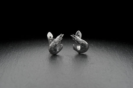 Check out these stunning shrimp silver earrings! 

Made from high-quality sterling silver, these earrings are both durable and stylish, making them the perfect accessory for any occasion. (etsy image id: 4586657498)