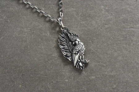 Made with high-quality materials, this pendant is both durable and elegant. Its sleek silver design and colorful parrot detailing make it the perfect accessory for any outfit. (etsy image id: 4608054826)