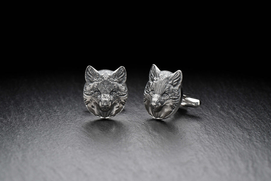 May include: A pair of silver fox head cufflinks. The cufflinks are round and feature a detailed fox head design. (etsy image id: 7689621560)