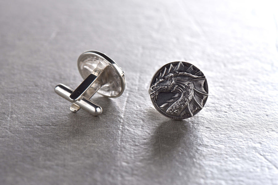 May include: A pair of silver cufflinks featuring a detailed dragon head design. (etsy image id: 7689558200)