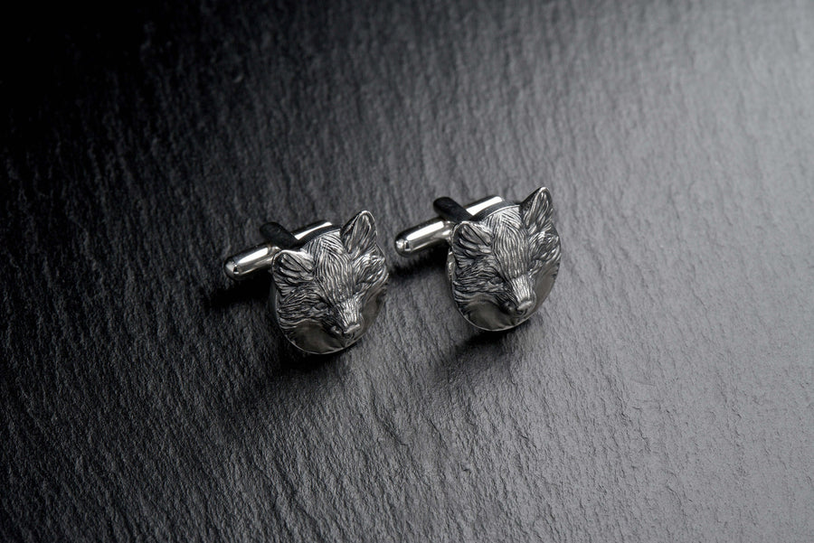 May include: A pair of silver fox head cufflinks. The cufflinks are round and feature a detailed fox head design. (etsy image id: 7689621560)