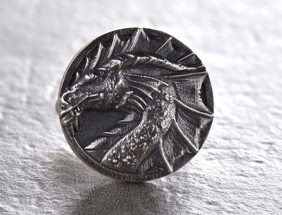May include: A pair of silver cufflinks featuring a detailed dragon head design. (etsy image id: 7689558200)