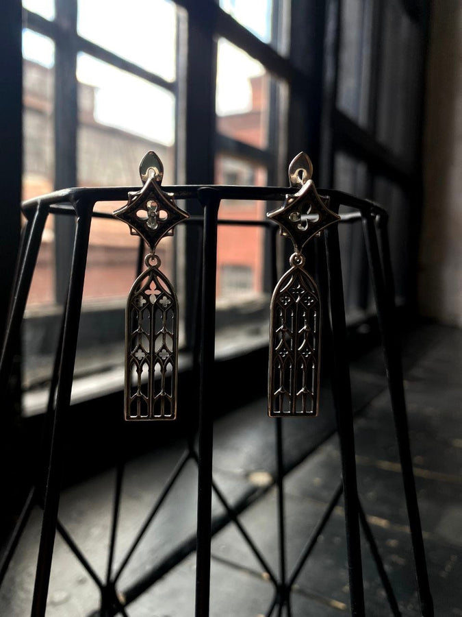 The image focuses on the interplay of light and shadow on the 925 sterling silver. The ridges of the arches are polished to a high shine, while the inner recesses are blackened with oxidation. This technique gives the earrings the visual weight of stone masonry while maintaining the lightness required for a comfortable ear dangle. (etsy image id: 7218591328)