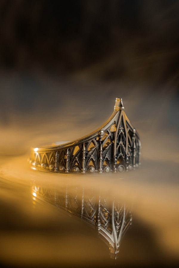 The spire represents the connection between the earth and the heavens, or high aspirations. The ribbed vaulting represents strength through structure. Wearing this ring as a "crown" on the finger symbolizes personal sovereignty and a dedication to higher ideals. It is a piece that commands respect. (etsy image id: 7976017075)