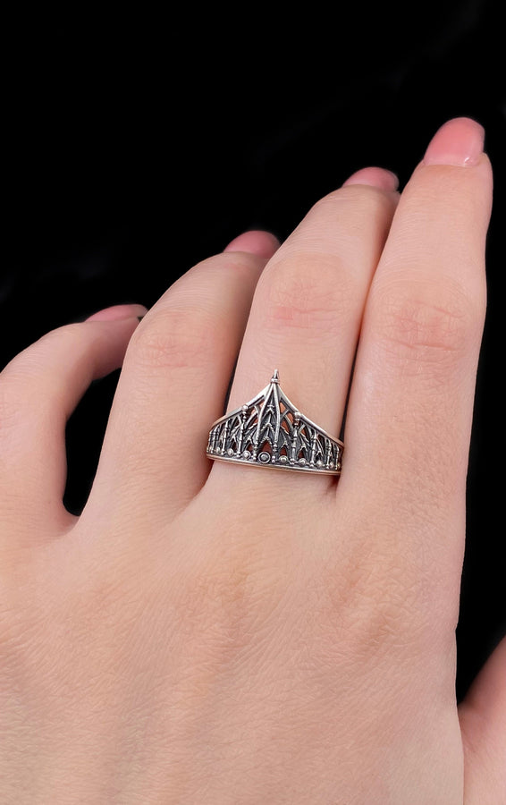 The spire represents the connection between the earth and the heavens, or high aspirations. The ribbed vaulting represents strength through structure. Wearing this ring as a "crown" on the finger symbolizes personal sovereignty and a dedication to higher ideals. It is a piece that commands respect. (etsy image id: 7976017075)