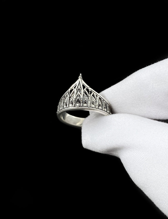 The spire represents the connection between the earth and the heavens, or high aspirations. The ribbed vaulting represents strength through structure. Wearing this ring as a "crown" on the finger symbolizes personal sovereignty and a dedication to higher ideals. It is a piece that commands respect. (etsy image id: 7976017075)