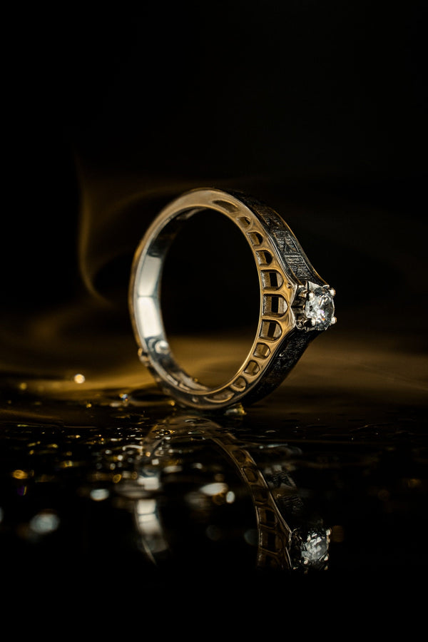 A professional studio photograph of a matching two-piece sterling silver wedding ring set. Both rings feature a prominent, raised Greek-style cross motif in the center, which holds a round, bezel-set white crystal. The interior of the cross arms has a fine, cross-hatched grid texture. Along the sides of the high-polished silver bands are recessed, four-lobed quatrefoil shapes. The rings are presented against a pitch-black background, making the p __etsy:8051335185