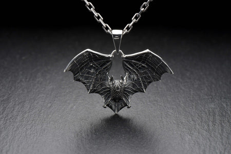 Featuring a detailed bat with outstretched wings, our unique design is sure to stand out. Don't let the darkness keep you down—power up your style with a silver bat pendant today! (etsy image id: 6086867201)