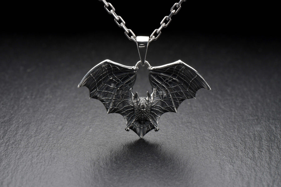 Featuring a detailed bat with outstretched wings, our unique design is sure to stand out. Don't let the darkness keep you down—power up your style with a silver bat pendant today! (etsy image id: 6086867201)