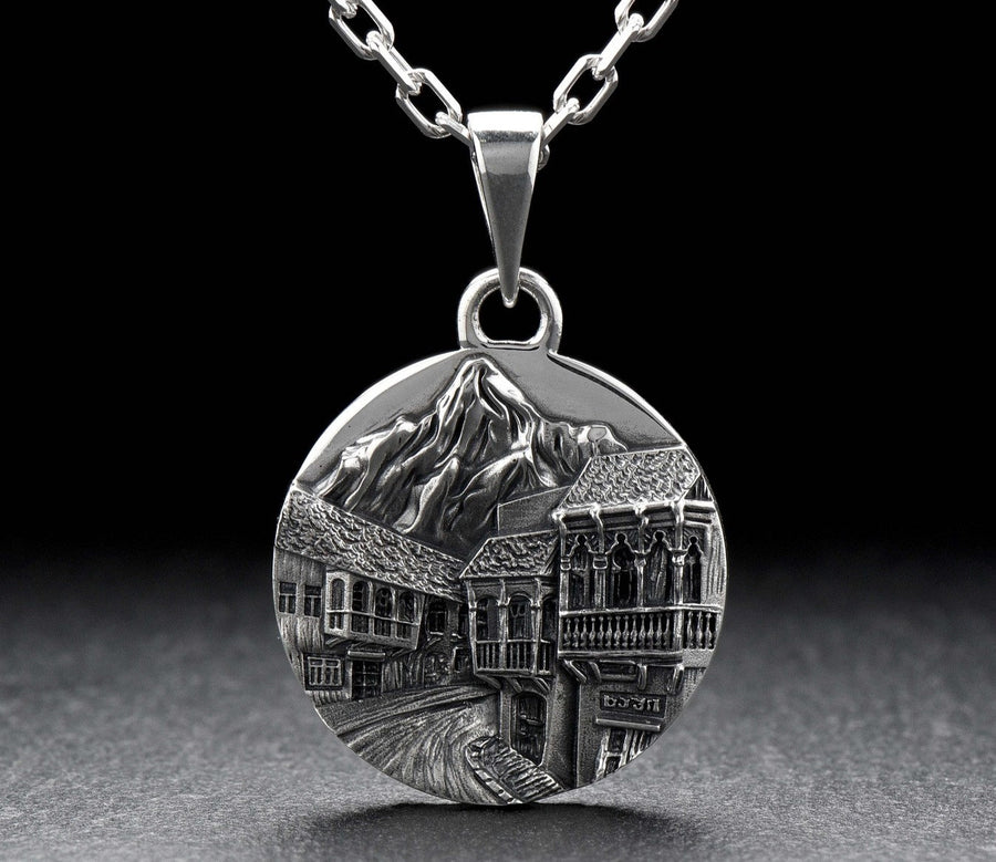 This beautiful pendant is the perfect souvenir to remember your trip to the beautiful city of Tbilisi. It features a detailed, hand-crafted design of the skyline of Tbilisi, Georgia.