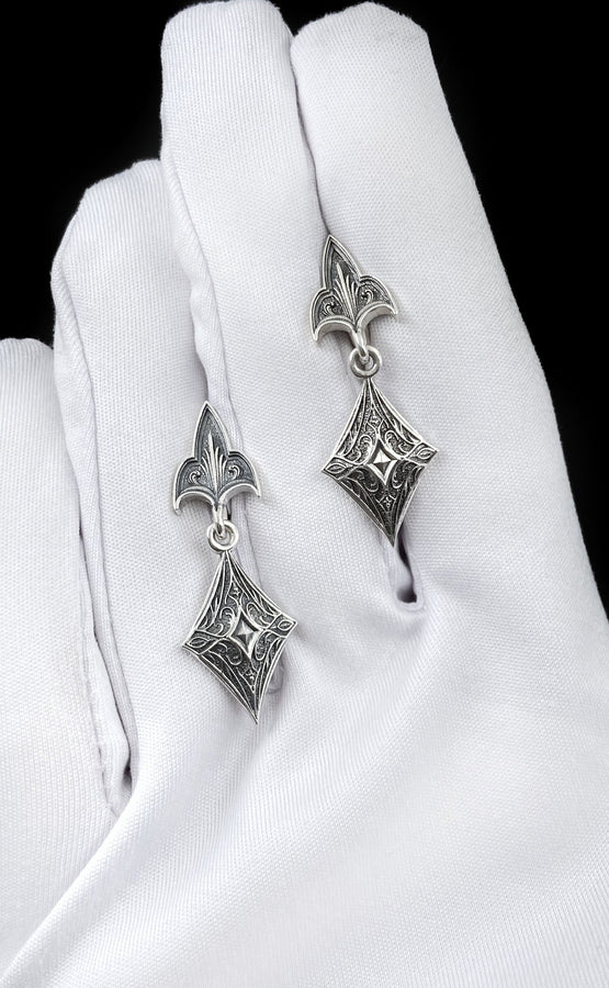 Embrace the dark allure of Gothic fashion with our Sterling Silver Gothic Earrings. Crafted with meticulous attention to detail, these earrings exude sophistication and mystique, perfect for those who appreciate the darker side of elegance. The mood is regal and sophisticated, appealing to fans of "Royal Core" aesthetics, historical dramas, or Victorian fashion. (etsy image id: 6150688147)