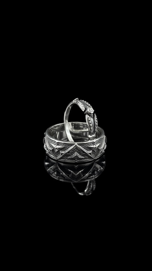 Detailed view of the ring's texture, showing the stippled, hammered finish inside the recessed arches. This "granulation" effect adds a raw, artisan quality to the piece, distinguishing it from mass-produced jewelry. The 925 sterling silver has been treated with sulfur to achieve a permanent dark patina in the low points, ensuring the architectural pattern remains visible even with daily wear. The metal looks solid and durable, suit (etsy image id: 7305774839)