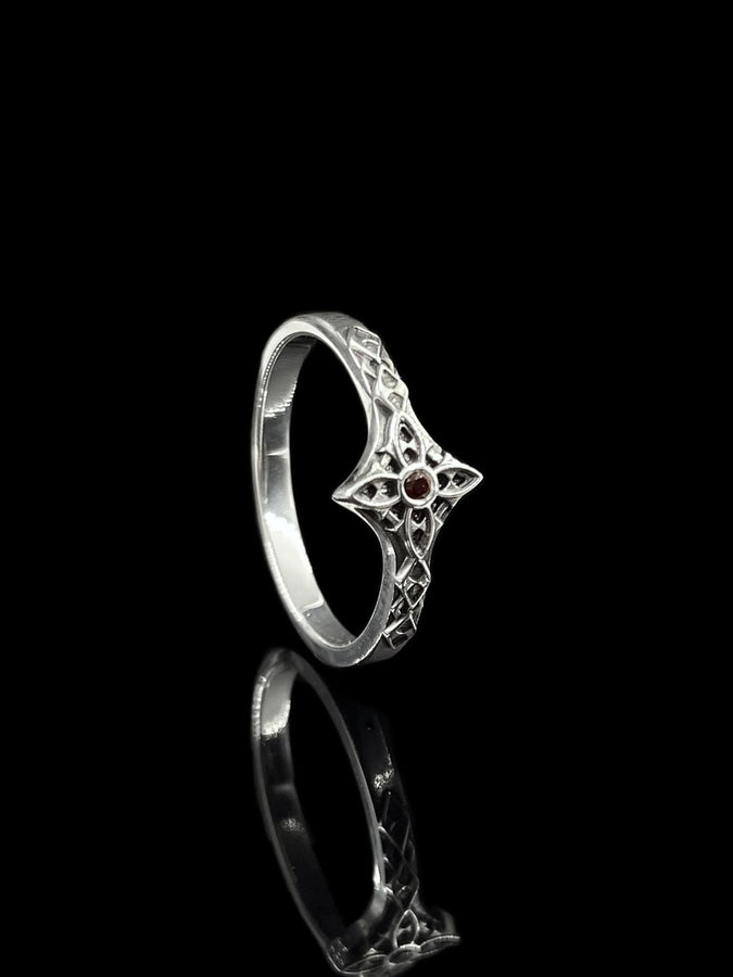 A professional studio photograph of a matching two-piece sterling silver wedding ring set. Both rings feature a prominent, raised Greek-style cross motif in the center, which holds a round, bezel-set white crystal. The interior of the cross arms has a fine, cross-hatched grid texture. Along the sides of the high-polished silver bands are recessed, four-lobed quatrefoil shapes. The rings are presented against a pitch-black background, making the p __etsy:8051335185