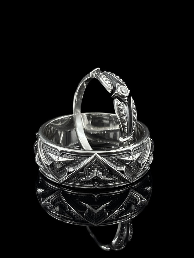 Detailed view of the ring's texture, showing the stippled, hammered finish inside the recessed arches. This "granulation" effect adds a raw, artisan quality to the piece, distinguishing it from mass-produced jewelry. The 925 sterling silver has been treated with sulfur to achieve a permanent dark patina in the low points, ensuring the architectural pattern remains visible even with daily wear. The metal looks solid and durable, suit (etsy image id: 7305774839)