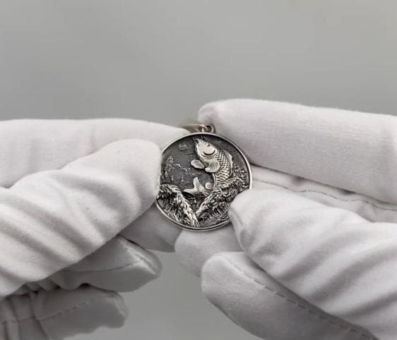 This exquisite pendant showcases the graceful form of a Koi Carp, meticulously crafted in sterling silver. The intricate detailing captures the essence of these magnificent fish, from their flowing fins to their delicate scales. (etsy image id: 5077863619)